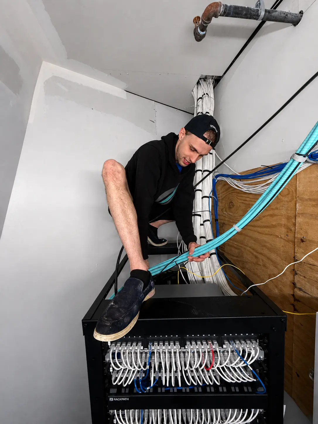 Jack routing structured cabling into a populated network rack