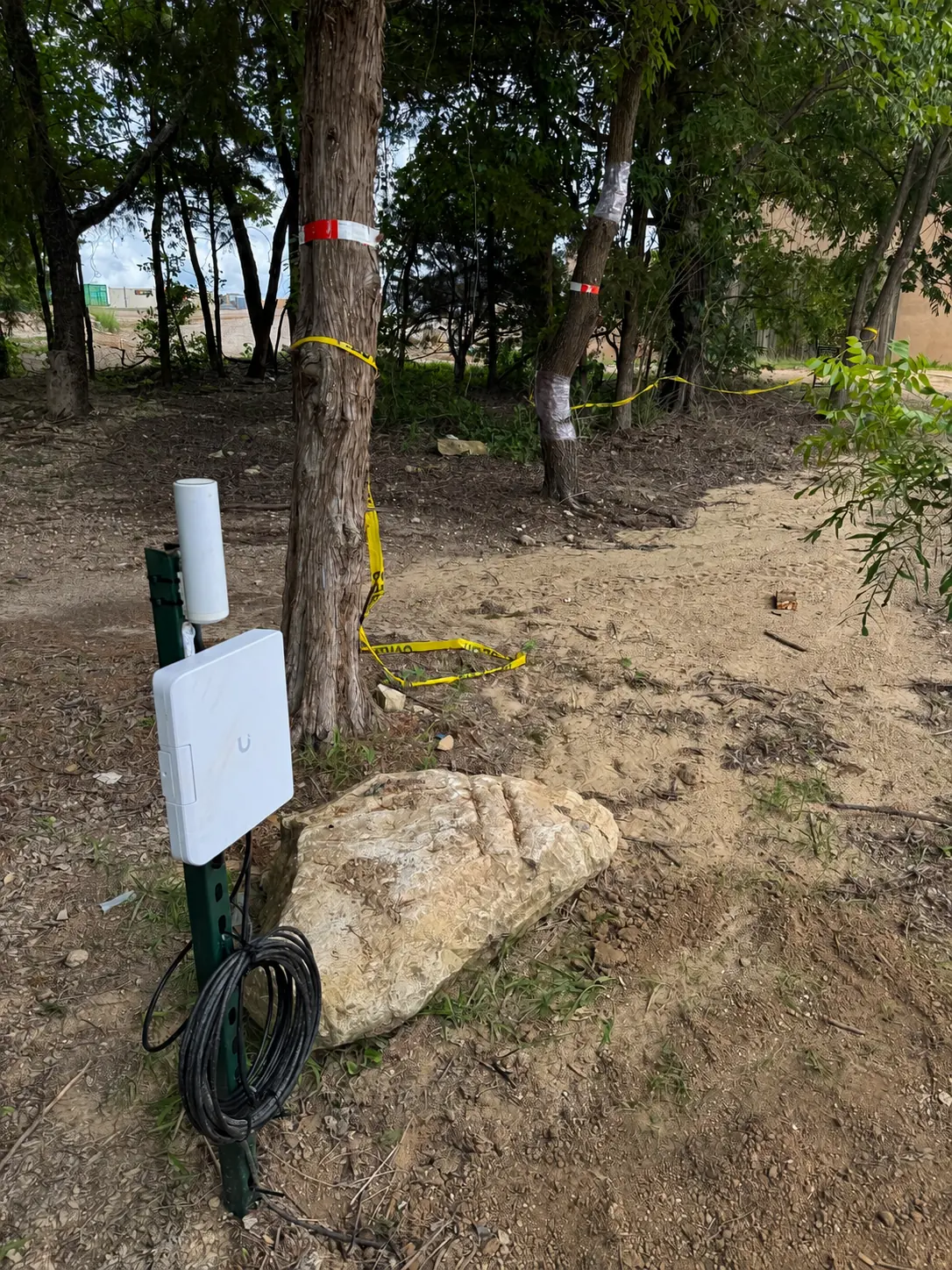 Outdoor wireless bridge equipment and cable route through a wooded property